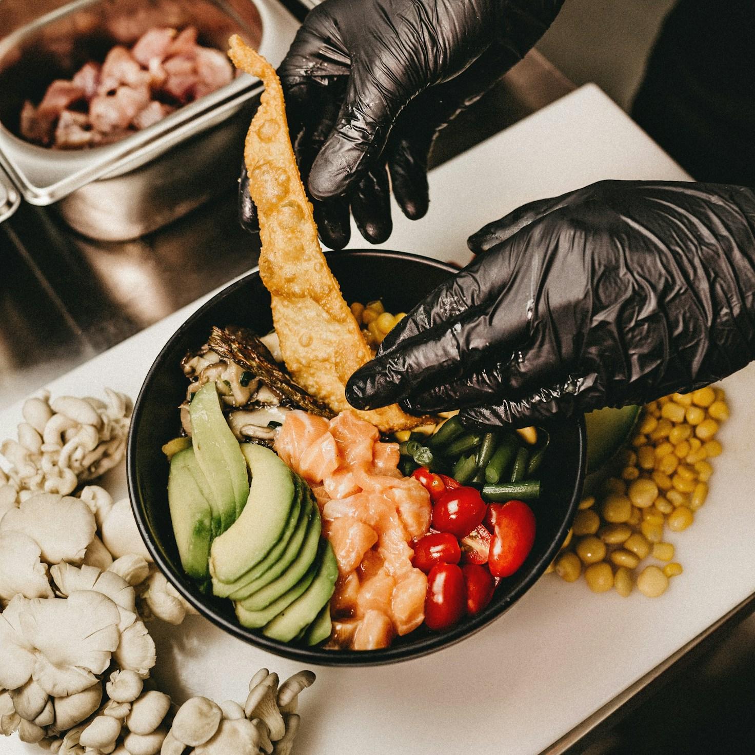 Community members collaborating in a modern kitchen space, sharing recipes and cooking techniques
